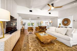 a living room with a white couch and a table at Lake Access Pool Loungers Fire Pit Grill in McQueeney +36 photos