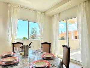 a dining room with a table and chairs and a large window at Blu Mare Casa Vacanza in La Maddalena