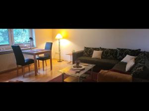 a living room with a couch and a table at Ferienwohnungen und Monteurzimmer Eggstedter Moor in Eggstedt