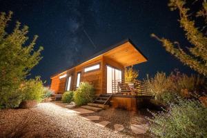 a cabin in the woods at night with the sky at Escalante Escapes Moon Lily- Bunk Escape in Escalante