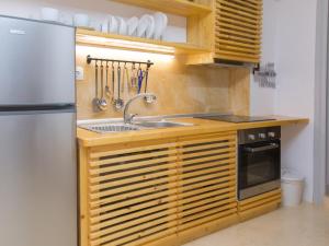 a kitchen with a sink and a refrigerator at Alleyway House in Hydra