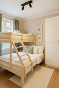 a bedroom with two bunk beds and a ceiling fan at Apartment Bergen Center - Quiet Gem - Minimum Age 25 in Bergen