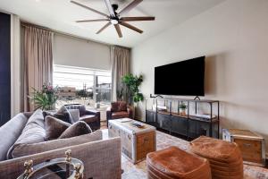 a living room with a couch and a flat screen tv at Hanger - A Birdy Vacation Rental in San Antonio
