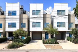 a white building with trees in front of it at Hanger - A Birdy Vacation Rental in San Antonio
