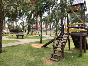 a playground with a slide in a park at Pedacinho do céu in Dourados
