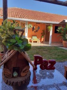 a house with a bird bath with a plant in it at Quarto Privativo com Banheiro no Centro in Bonito
