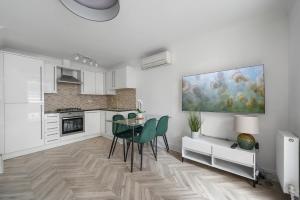 a kitchen with a table and chairs and a painting on the wall at Modern Apartment Charing Cross - Aircon in London +30 photos