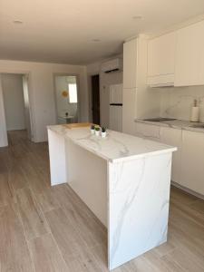 a kitchen with a white counter top in a room at Kilians apartment 4 in Castellón de la Plana