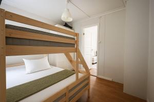 a bedroom with two bunk beds and a hallway at Central & Quiet by Bryggen - Minimum Age 25 in Bergen