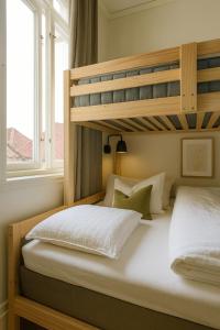 two bunk beds in a room with a window at Delightful Bryggen Apartment - Minimum Age 25 in Bergen