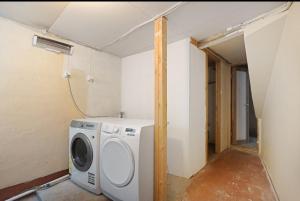 a laundry room with a washing machine in it at Delightful Bryggen Apartment - Minimum Age 25 in Bergen