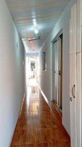 an empty hallway with a wooden floor in a house at Refúgio Central in Chapada dos Guimarães +5 photos