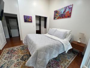 Ruth's Place Tiny Home Retreat 1 mile to town في Burnsville: غرفة نوم بها سرير ولوحة على الحائط