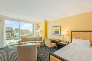 a hotel room with a bed and a desk at Trump Deluxe Studio Mountain View in Las Vegas