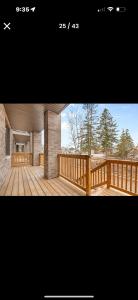 a picture of a house with a wooden deck at Entire place in Richmond hill Modern Luxury Home in Richmond Hill