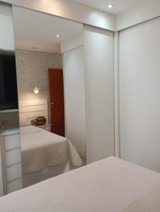 a bedroom with a mirror and a bed at Aconchego 1 in São Roque
