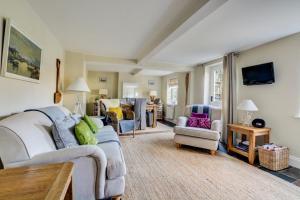 a living room with a couch and chairs at Rose Cottage in Sedgeford