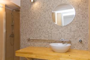 a bathroom with a sink and a mirror at Alleyway House in Hydra