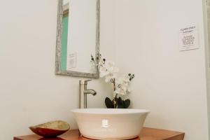 a bathroom with a bowl sink on a wooden table at Ocean Mist Suites in Kingstown