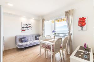 a living room with a table and chairs and a couch at Guaires 217 in Mogán