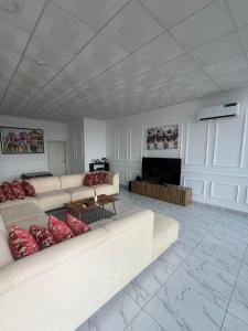 a living room with two white couches and a fireplace at Folio Spaces Luxury 2 bedroom Apartment in Lagos