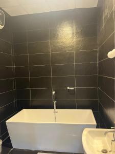 a bathroom with a bath tub and a sink at Folio Spaces Luxury 2 bedroom Apartment in Lagos