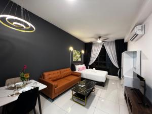 a living room with a couch and a table at The Majestic Gen Luxury Suites KLCC in Kuala Lumpur