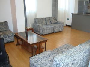 a living room with two couches and a coffee table at Sapphire View in Dirē Kʼalu
