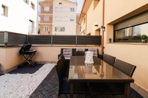 a table and chairs on the balcony of a building at La Caseta de Cercs, Barbecue y Pet Friendly in Sant Jordi de Cercs