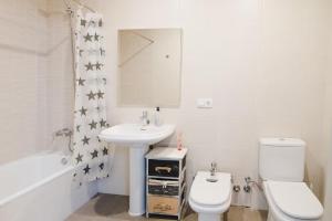 a white bathroom with a sink and a toilet at La Caseta de Cercs, Barbecue y Pet Friendly in Sant Jordi de Cercs +11 photos