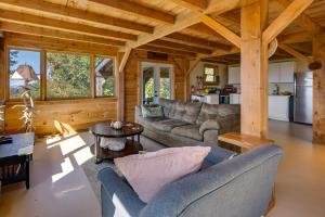 a living room with couches and a table in a cabin at Unplug, Unwind and Explore Remote Vermont Cabin in Sharon