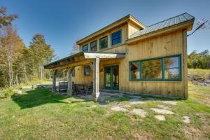 a large wooden house with a roof at Unplug, Unwind and Explore Remote Vermont Cabin in Sharon