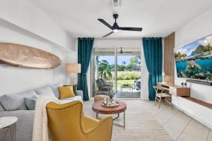 a living room with a couch and a table at New Sunsets 2 kings 1st floor in Waikoloa