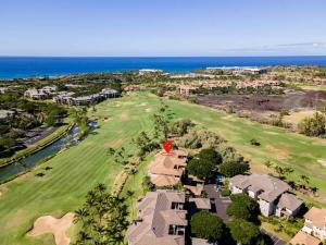 an aerial view of a golf course with the ocean at New Sunsets 2 kings 1st floor in Waikoloa