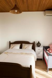 a bedroom with a large bed and a night stand at Maison F2 grand jardin Grand Est Paris in Gagny
