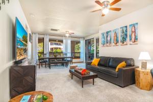 a living room with a couch and a table at New baths king bed open & tranquil pool hot tub in Waikoloa