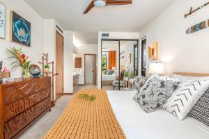 a bedroom with a bed and a living room at New baths king bed open & tranquil pool hot tub in Waikoloa