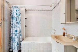 a white bathroom with a tub and a sink at Sentite en Casa in Buenos Aires