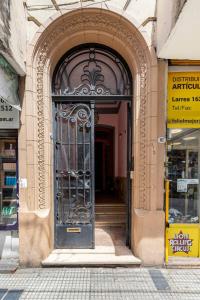 an entrance to a building with a black door at Sentite en Casa in Buenos Aires