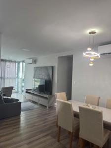 a dining room and living room with a table and chairs at Apartamento Torre Lumiar 3 quartos COP 30 e CIRIO in Belém
