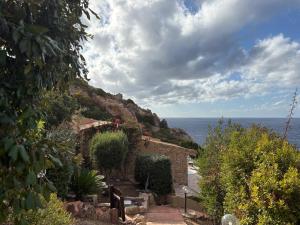 a house with a view of the ocean at Villa La Dolce Vista & Jacuzzi in Costa Paradiso