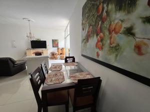 a dining room with a table with two pizzas on it at Casa Carito in Cali