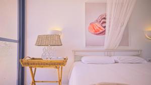 a bedroom with a bed and a table with a lamp at Villa MINEA II in Costa Calma