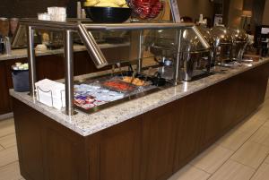 a buffet line in a restaurant with food at Best Western Plus Kennewick Inn in Kennewick