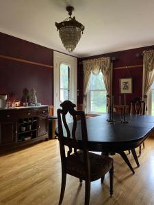 a dining room with a table and a chandelier at Franklin Manor in Franklin