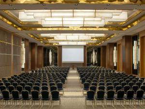 an empty room with chairs and a white screen at Movenpick Diyarbakir in Diyarbakır