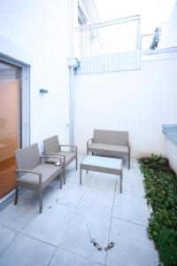 three benches sitting on a patio in a building at Bright apartments with spacious terraces offering comfort not far to Vienna's heart in Vienna
