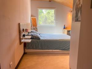 a bedroom with a bed and a window at Louprayt in Saint-Julien-Chapteuil