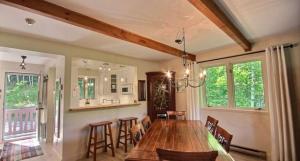 a dining room with a large wooden table and chairs at Le Belvedère Mont-Tremblant in Mont-Tremblant