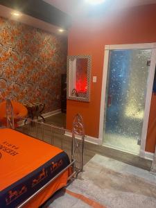a room with a bed and a mirror and a window at DC Private Room Luxury Spa Bath in Washington, D.C.